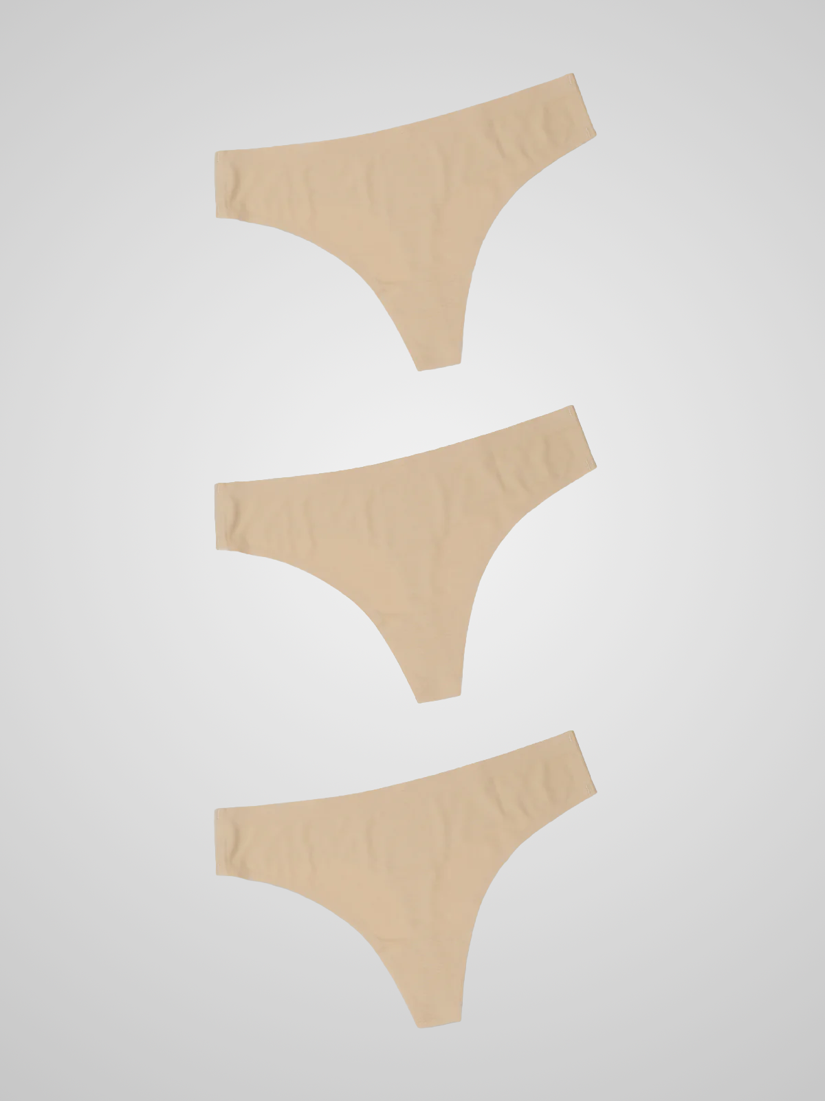Kit com 3 Calcinhas Fio Dental Sem Costura Segunda Pele Bege - R$23,30 cada